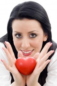 Woman client holding a red heart